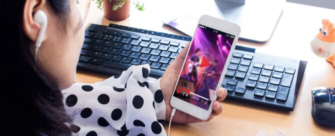 woman watching live stream of concert on her smartphone